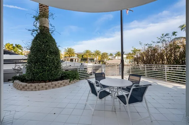 a view of balcony with a potted plant and outdoor seating