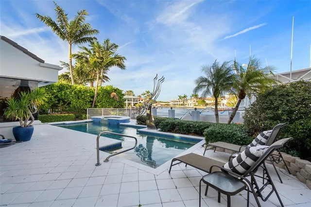 a view of swimming pool with outdoor seating and plants