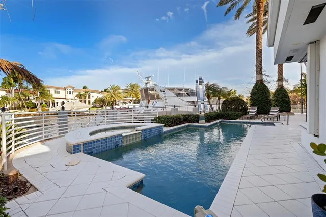 a view of a swimming pool with outdoor seating
