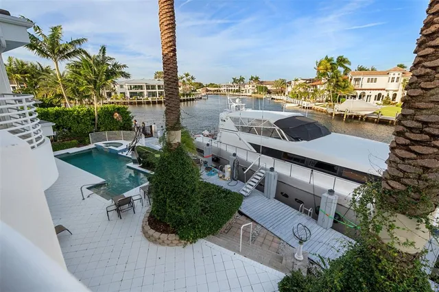 a view of a swimming pool with outdoor seating and plants
