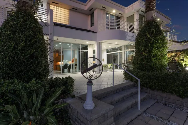 a view of a building with sitting area and garden