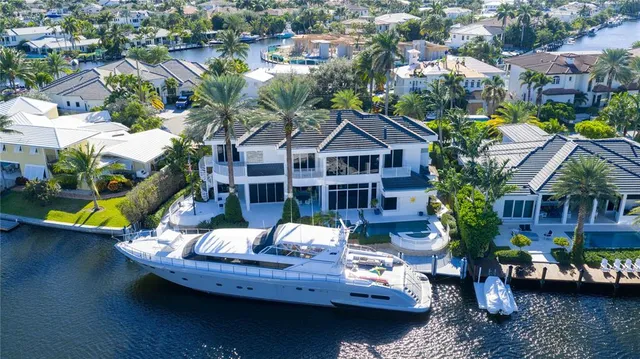 a view of a house with swimming pool and sitting area