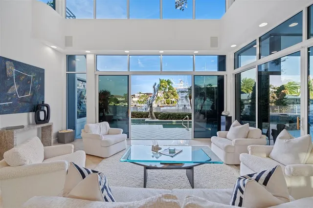 a living room with furniture and large windows