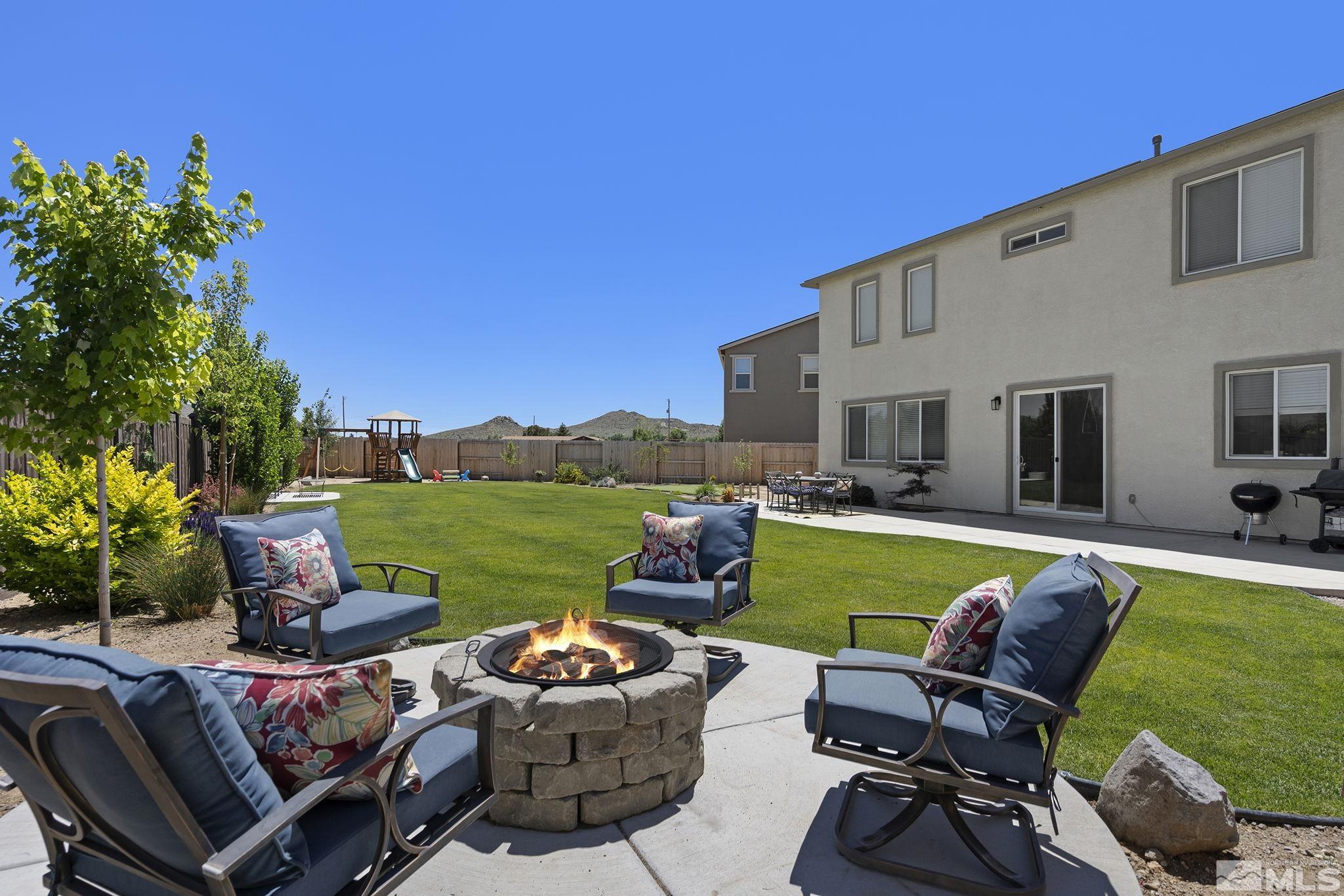 9166 Gulf Court Reno, NV 89506 - Photo 2 of 33 a view of a swimming pool and lounge chairs in back yard of the house