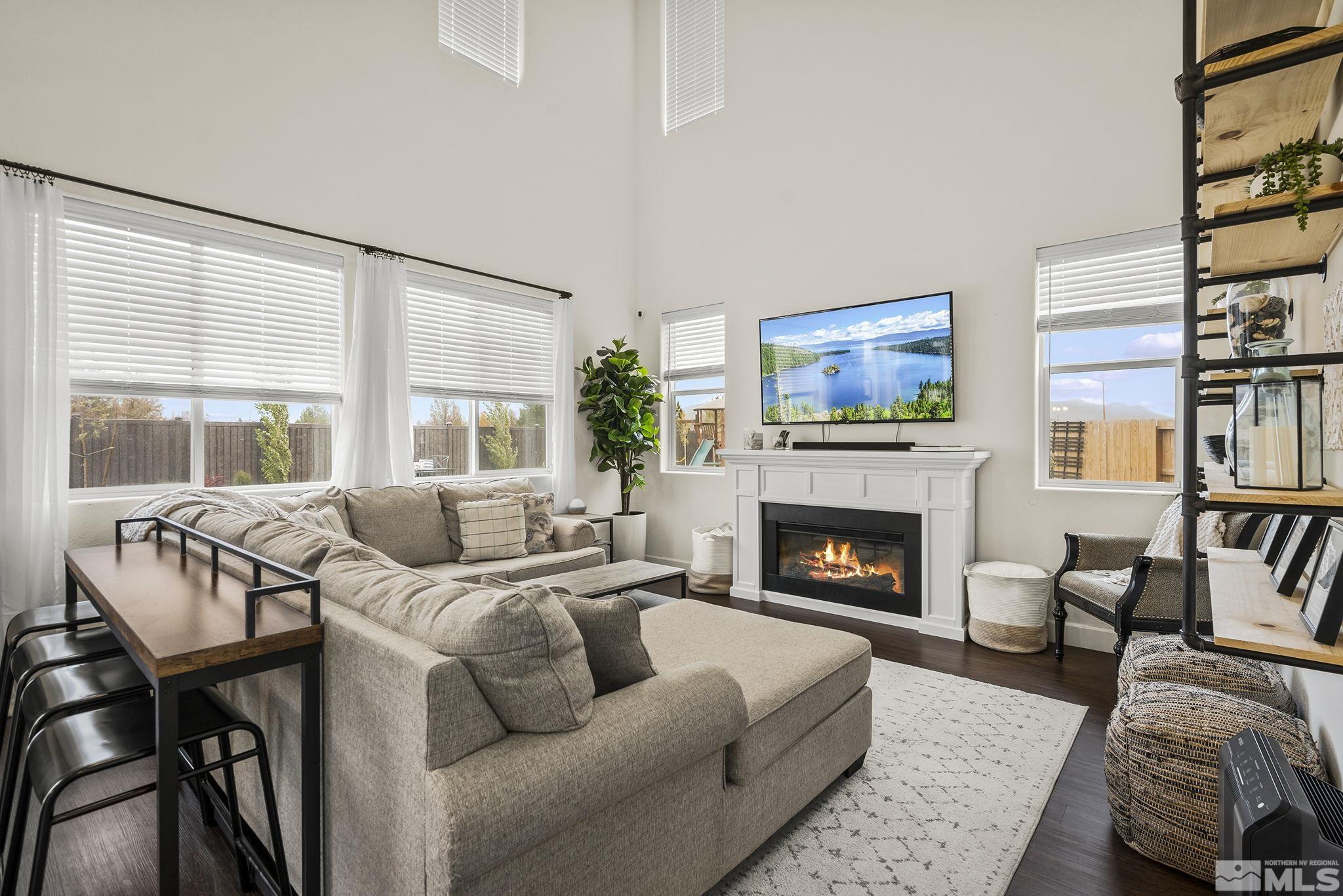 9166 Gulf Court Reno, NV 89506 - Photo 6 of 33 a living room with furniture fireplace and a large window