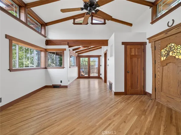 a view of empty room with wooden floor