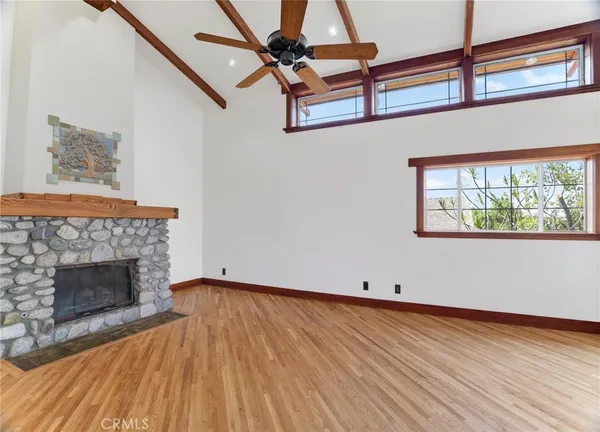 a view of a room with wooden floor and windows