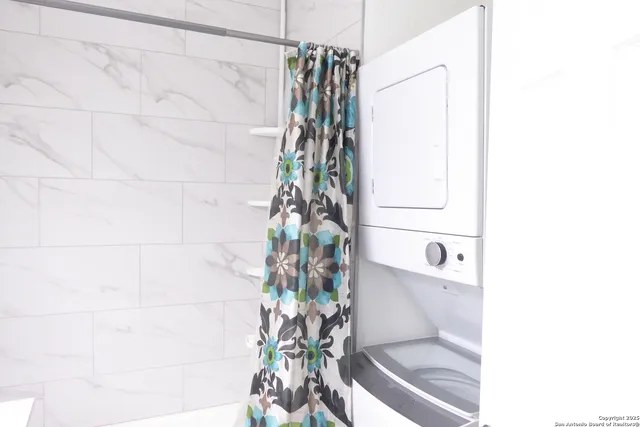 a bathroom with a shower curtain and a sink