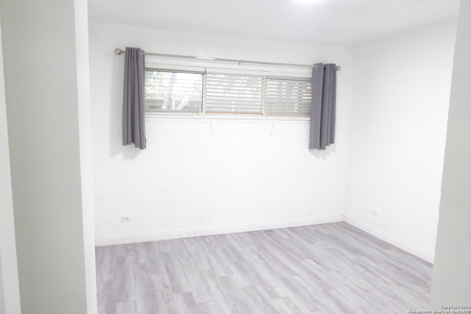 255 East Rampart Drive, Unit 211 San Antonio, TX 78216 - Photo 15 of 17 a view of a small space with wooden floor and a window