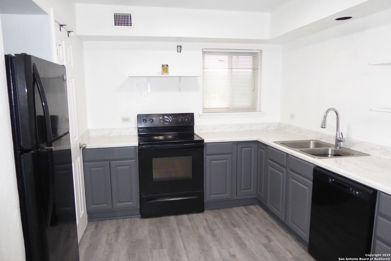 255 East Rampart Drive, Unit 211 San Antonio, TX 78216 - Photo 8 of 17 a kitchen with a refrigerator and a sink