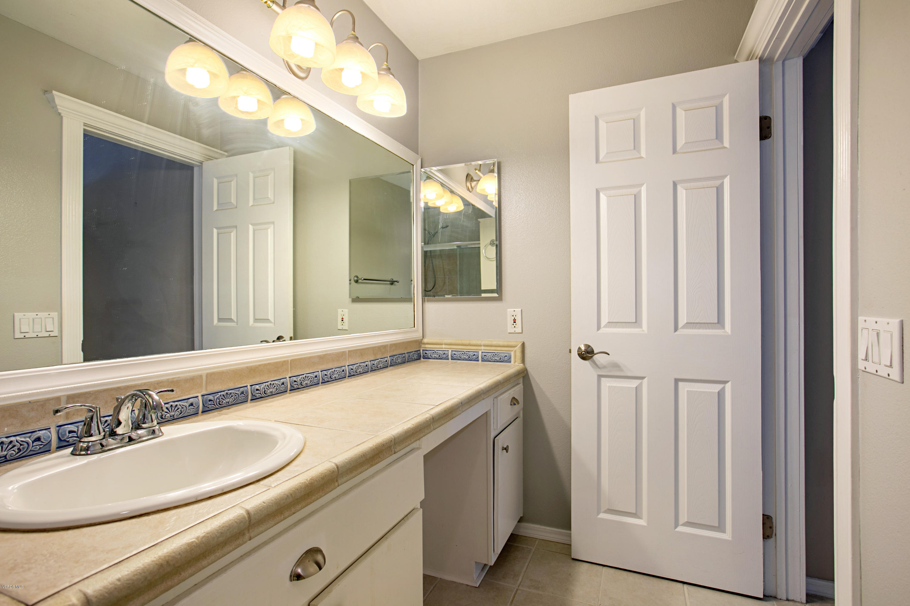 659 Arneill Road Camarillo, CA 93010 - Photo 21 of 25 a bathroom with a sink and a mirror