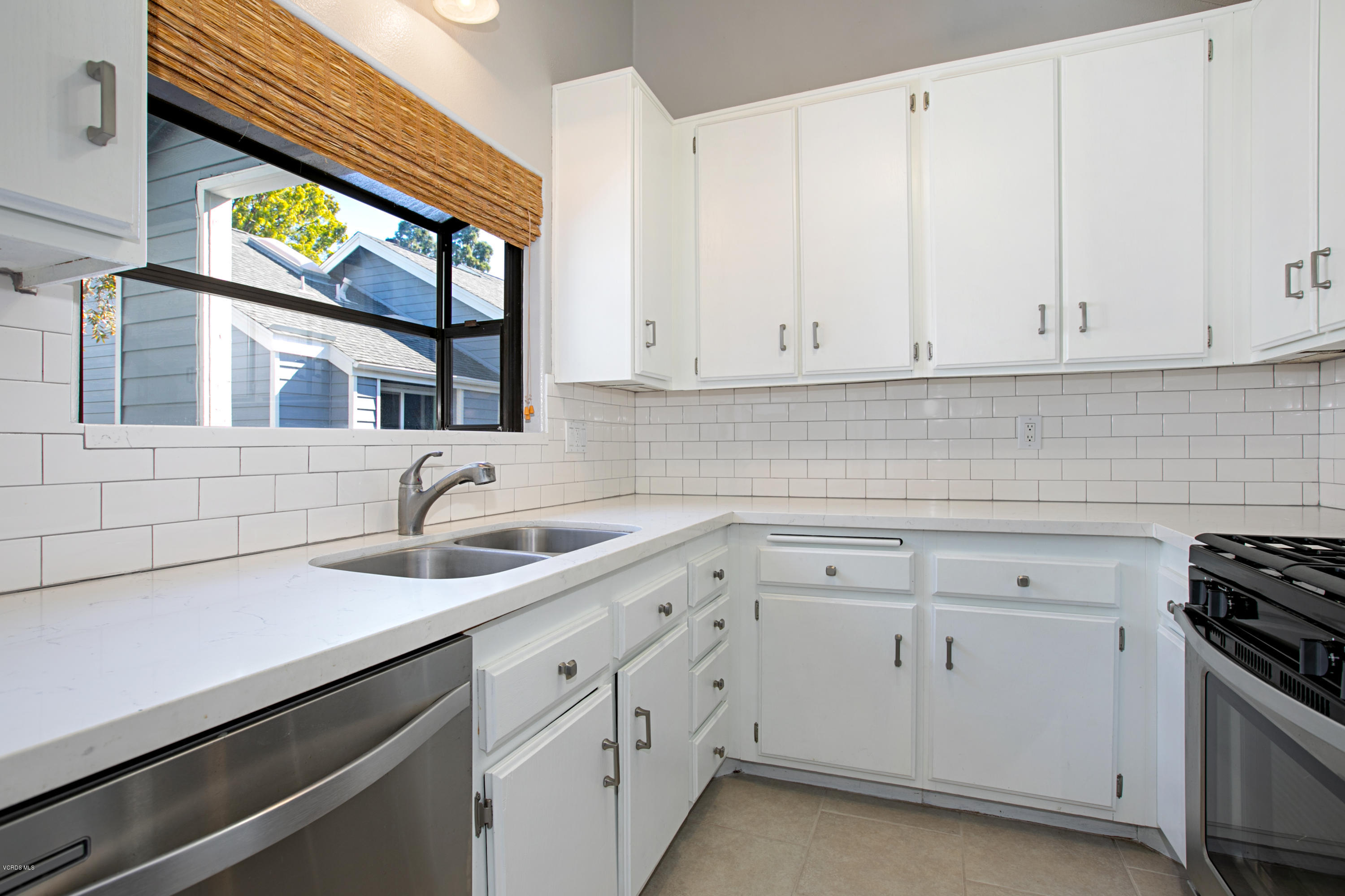 659 Arneill Road Camarillo, CA 93010 - Photo 8 of 25 a kitchen with stainless steel appliances white cabinets and a sink