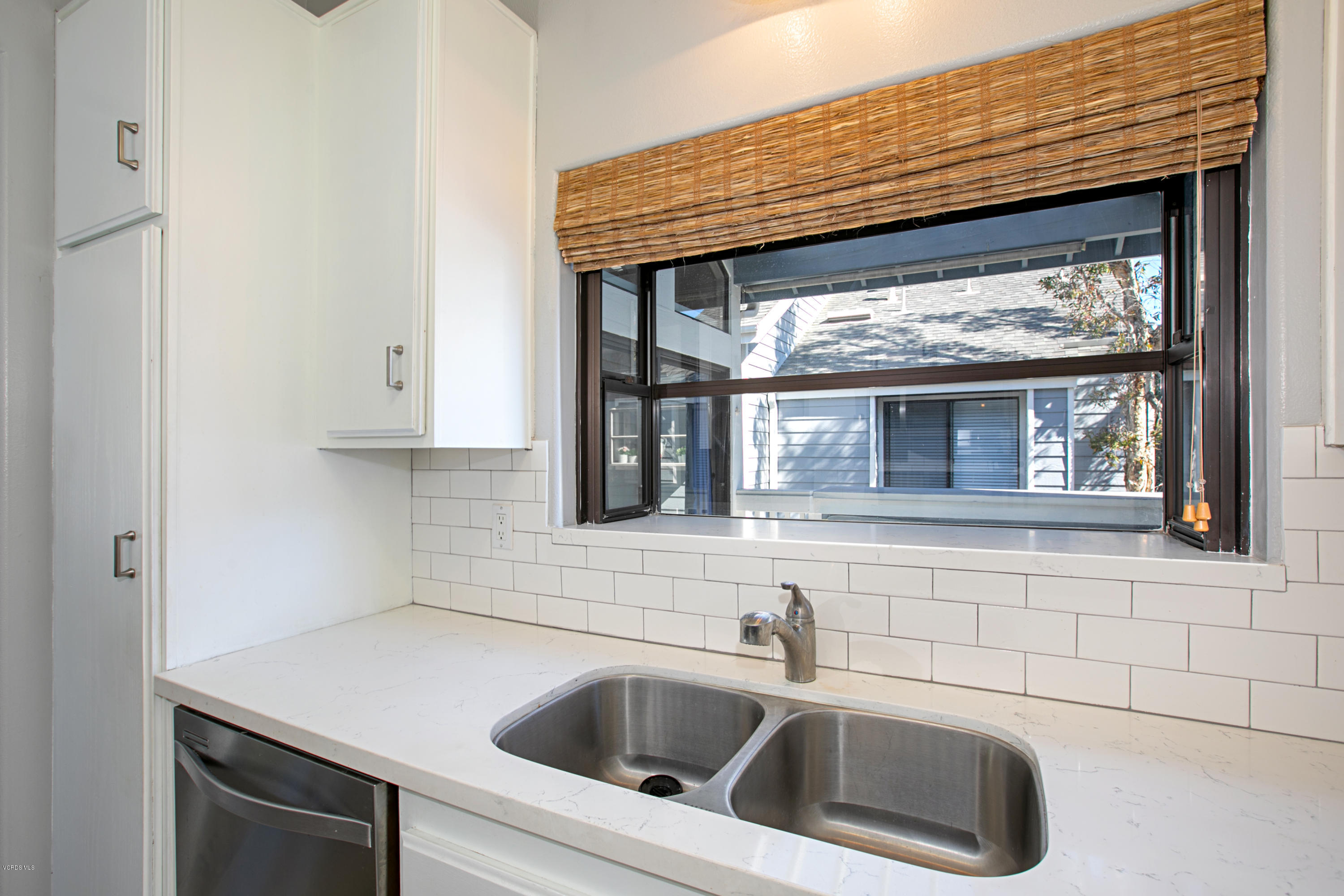 659 Arneill Road Camarillo, CA 93010 - Photo 9 of 25 a kitchen with a sink cabinets and a window