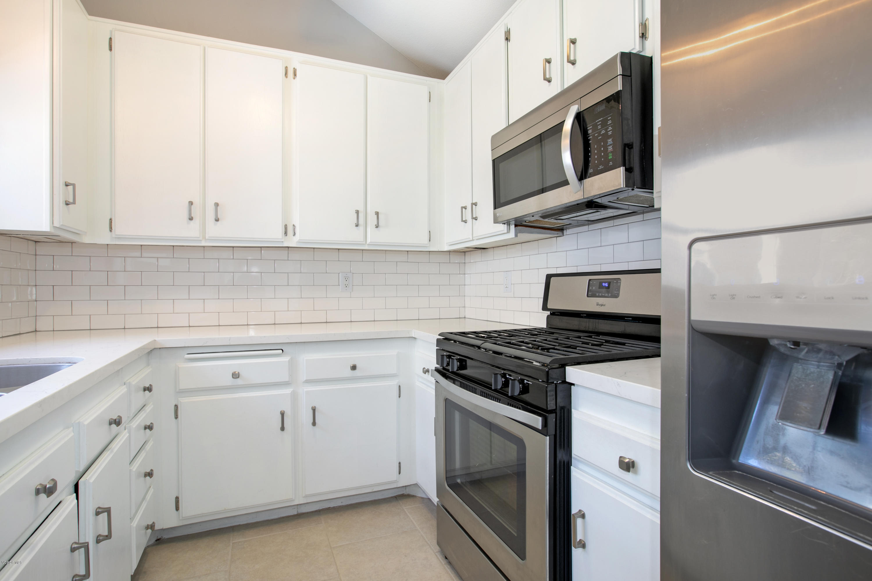 659 Arneill Road Camarillo, CA 93010 - Photo 10 of 25 a kitchen with white cabinets stainless steel appliances and sink