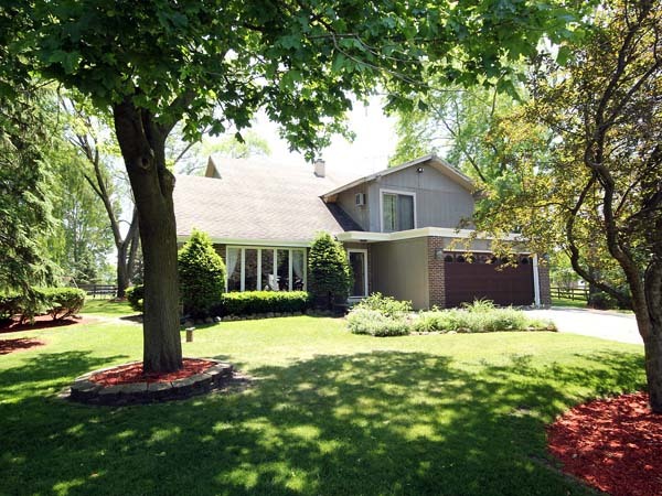 40W977 Plank Road Elgin, IL 60124 - Photo 1 of 38 a front view of a house with a yard