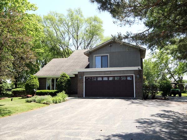 40W977 Plank Road Elgin, IL 60124 - Photo 2 of 38 a front view of a house with a yard and garage