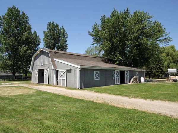 40W977 Plank Road Elgin, IL 60124 - Photo 23 of 38 a front view of a house with a garden and trees