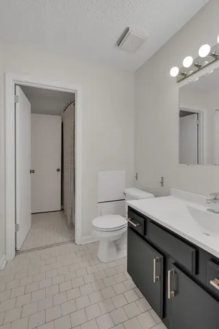 a bathroom with a sink a toilet and mirror