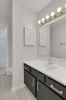 a bathroom with a sink a vanity and a mirror