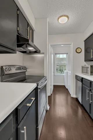 a kitchen with stainless steel appliances a sink stove and cabinets