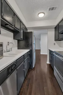 a kitchen with stainless steel appliances a sink dishwasher a stove and cabinets