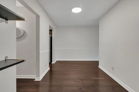 a view of hallway with wooden floor