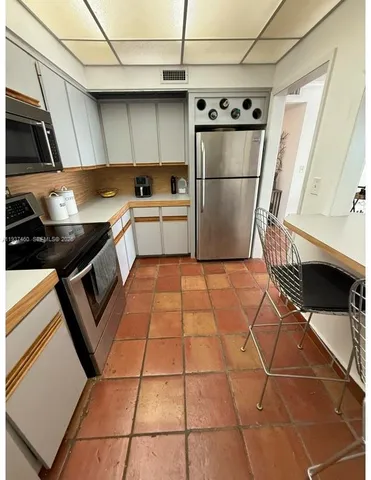 a kitchen with a sink a refrigerator and washer