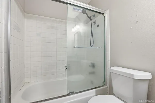 a bathroom with a shower and a toilet