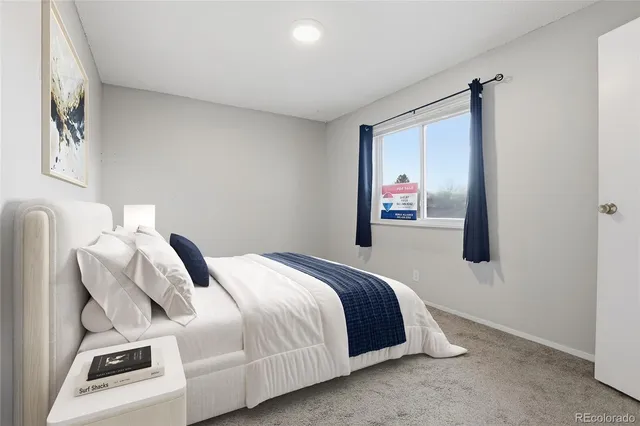 a bedroom with a bed and a mirror