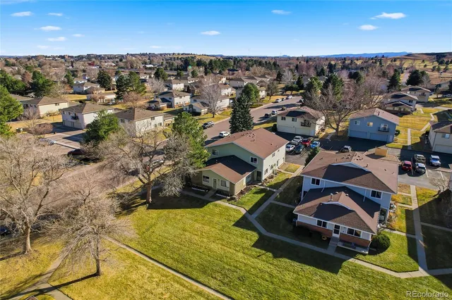 a view of a house with yard and sitting area