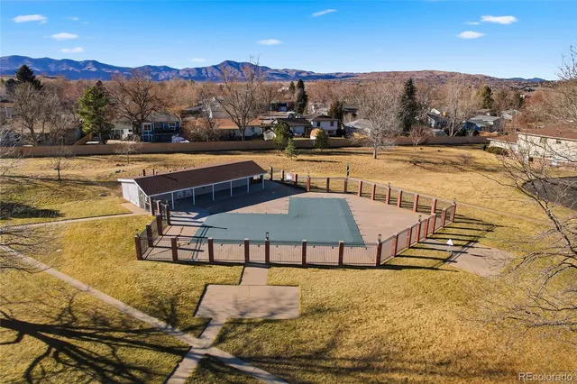 a view of a swimming pool with a table and chairs