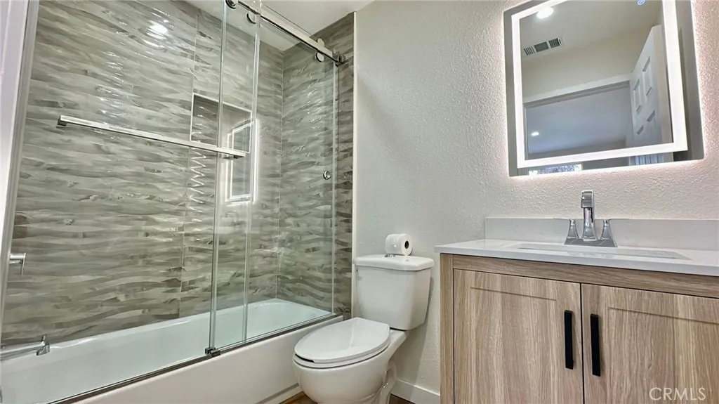 508 West Pear Street Compton, CA 90222 - Photo 11 of 14 a bathroom with a granite countertop toilet sink and shower