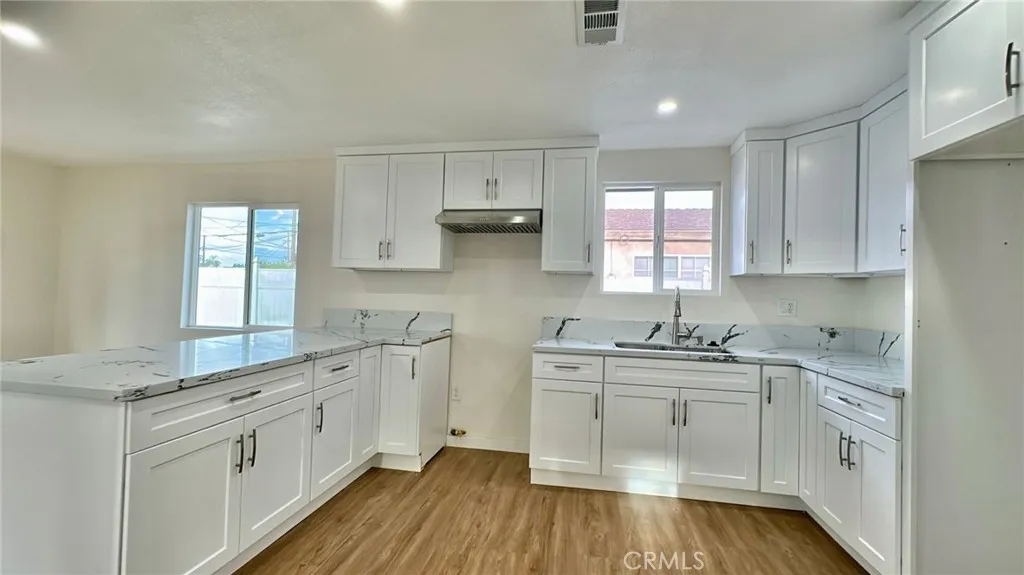 508 West Pear Street Compton, CA 90222 - Photo 6 of 14 a kitchen with white cabinets sink and window