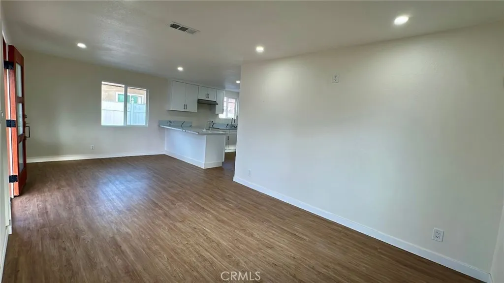 508 West Pear Street Compton, CA 90222 - Photo 9 of 14 an empty room with wooden floor and windows
