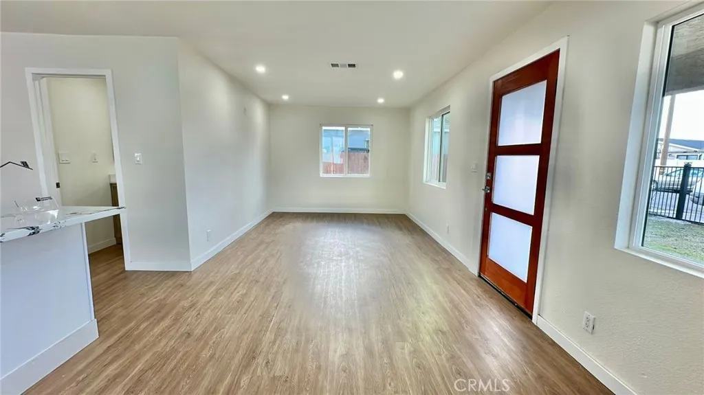 508 West Pear Street Compton, CA 90222 - Photo 10 of 14 wooden floor in an empty room with a window