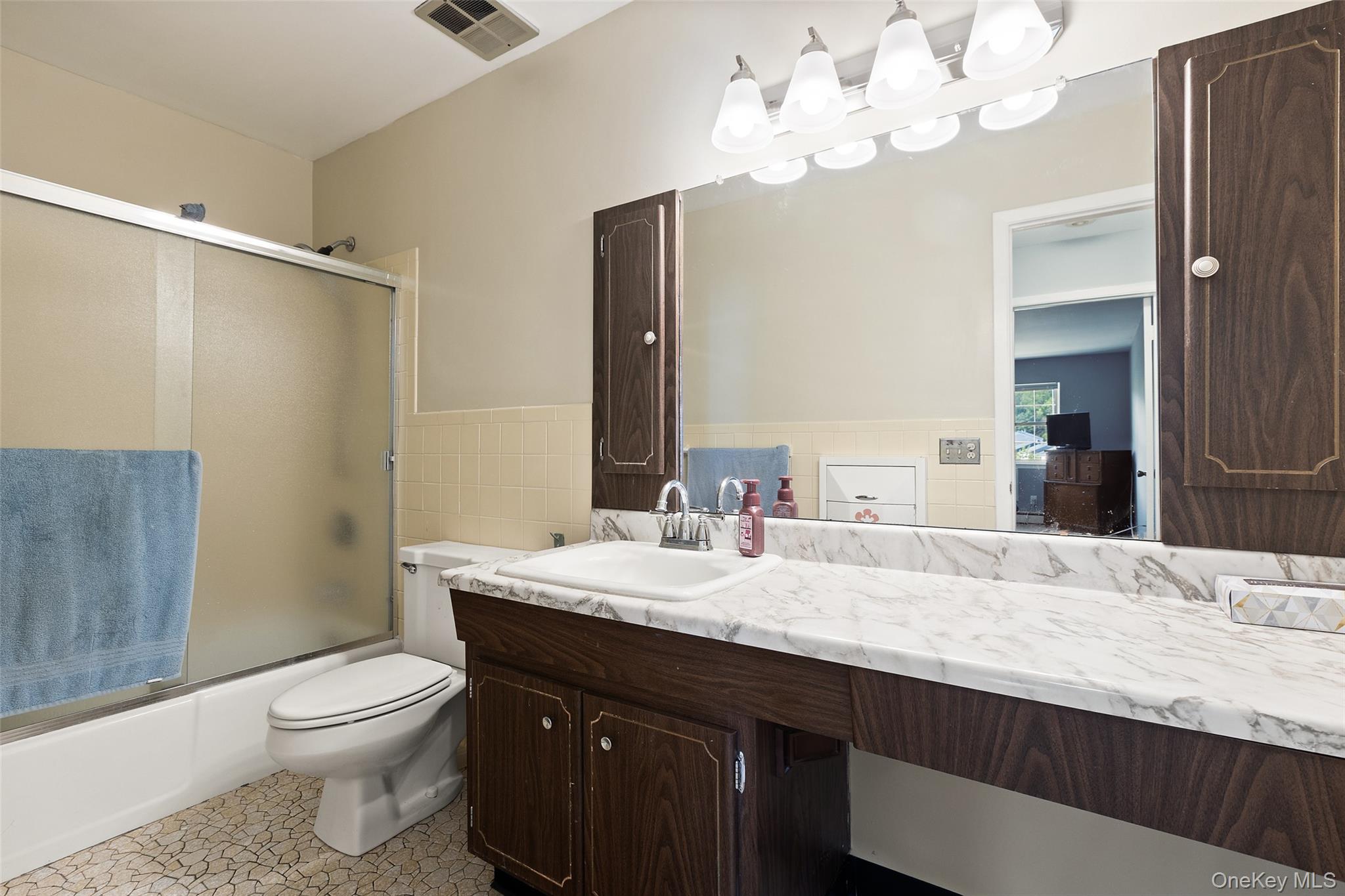 1840 Crompond Road, Unit 5C2 Peekskill, NY 10566 - Photo 15 of 27 a bathroom with a granite countertop sink a toilet and a mirror