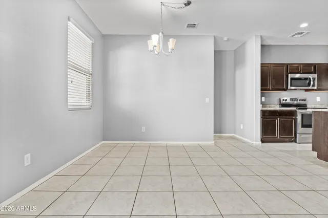 a view of an empty room with a kitchen