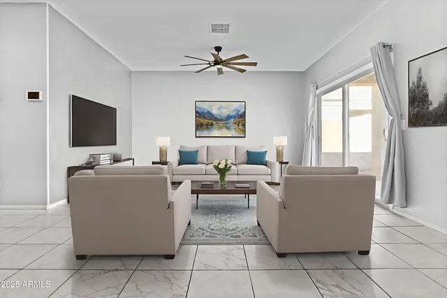 a living room with couches and a flat screen tv