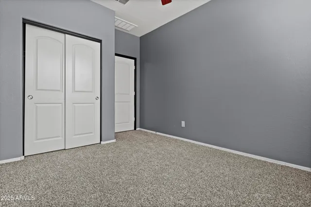 an empty room with closet area