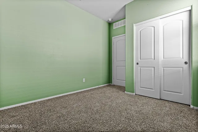 a bathroom with a granite countertop toilet sink and mirror