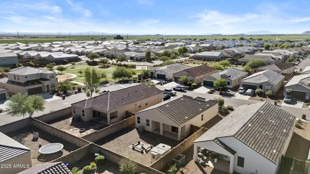 an aerial view of residential building with green space