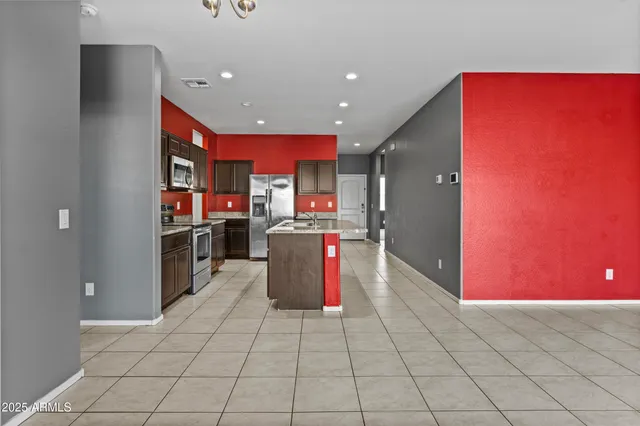 a kitchen with stainless steel appliances granite countertop a refrigerator and stove top oven