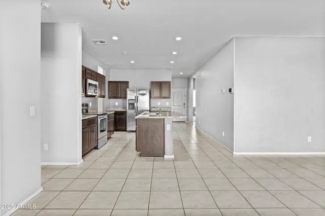 a kitchen with stainless steel appliances a refrigerator and a stove top oven