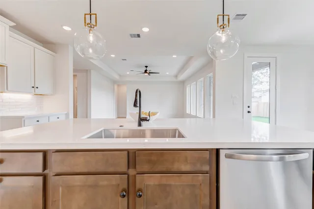 a kitchen with a sink and cabinets