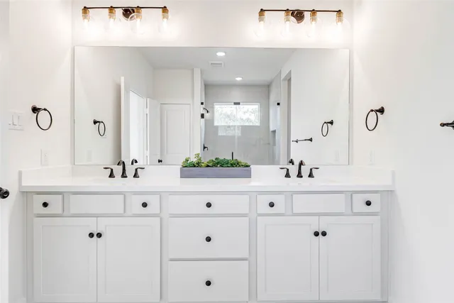 a bathroom with vanity sink and mirror