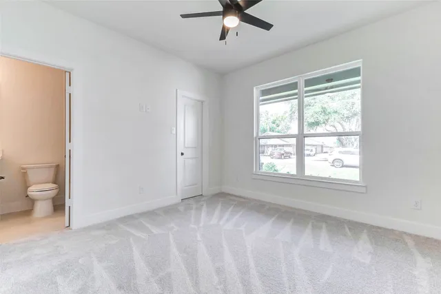 a view of a livingroom with a ceiling fan and window