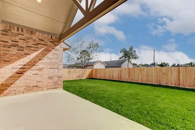 front view of a brick house with a yard