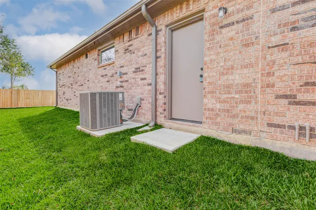 a view of yard with grass and wooden fence