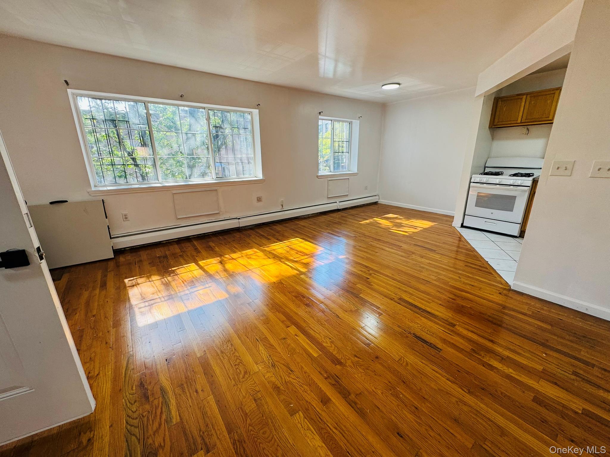 53 West 192nd Street, Unit 3A Bronx, NY 10468 - Photo 1 of 14 a view of empty room with wooden floor and fan