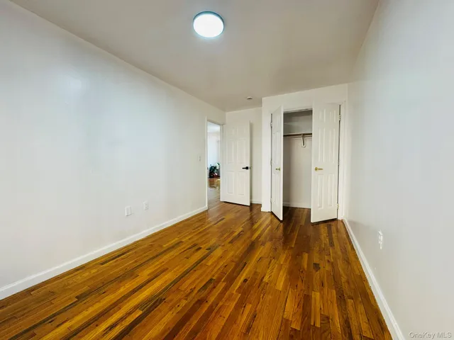 a view of a room with wooden floor and closet